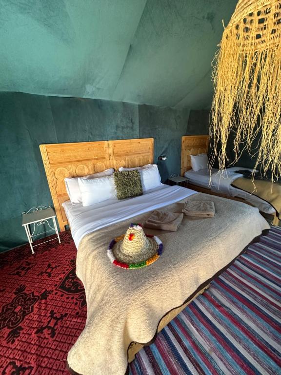 a bedroom with a large bed with a rug at Luxury camp in Hassilabied
