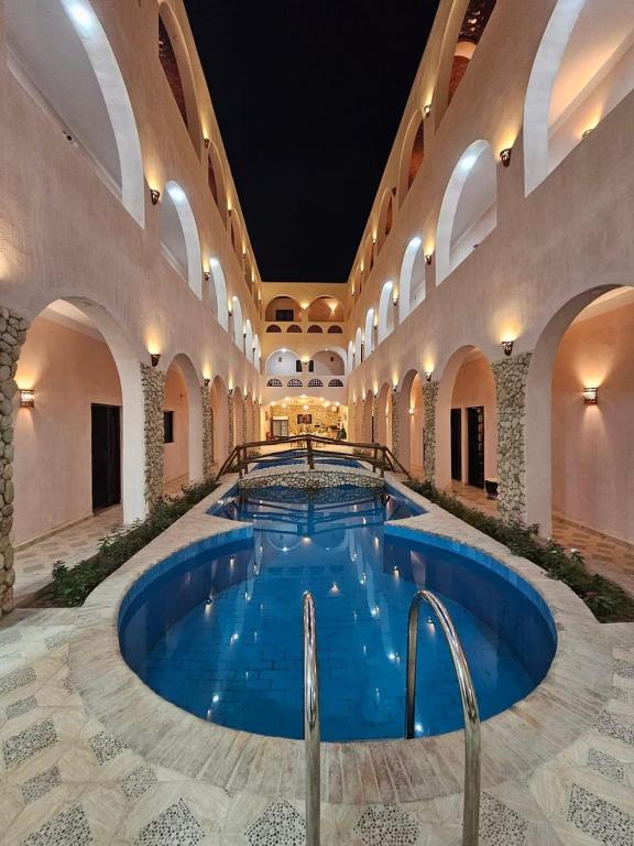 a large swimming pool in a large building with an indoor at amzran hotel siwa امزران سيوة in Siwa