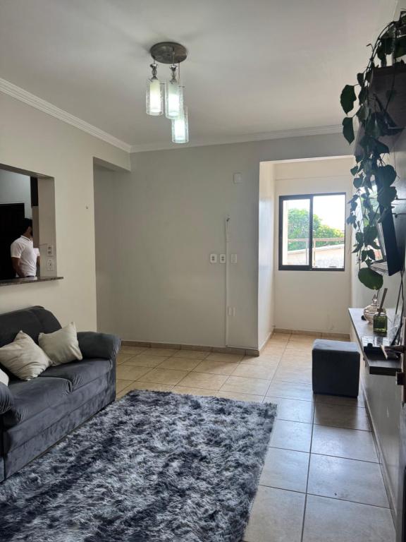 a living room with a couch and a rug at Centro Brasil Apartamento in Santarém