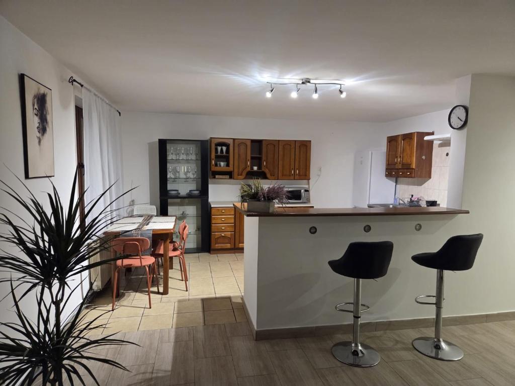 a kitchen and dining room with a table and chairs at Willa MARSI in Stalowa Wola