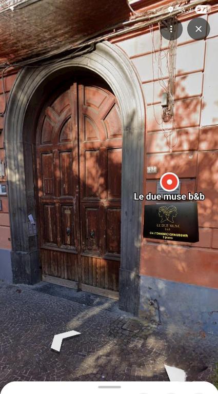 a large wooden door on the side of a building at Le Due Muse b&b in Pagani