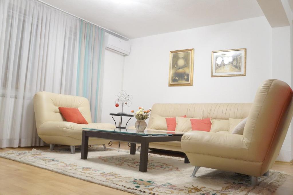 a living room with a couch and a coffee table at Sarajevo Hills Apartment in Sarajevo