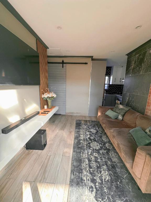 a living room with a couch and a table at 29 on Windsor-2 Bedroom House in Silver Sands