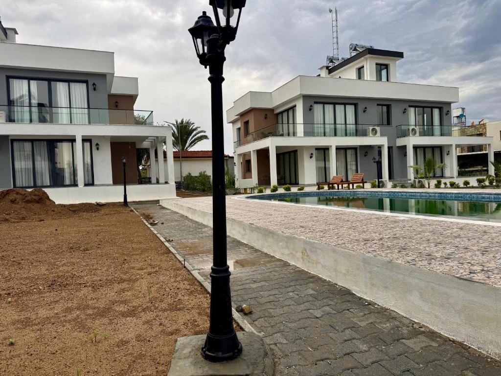 a black street light in front of a house at Soğular Apartments 1 in Aglantzia