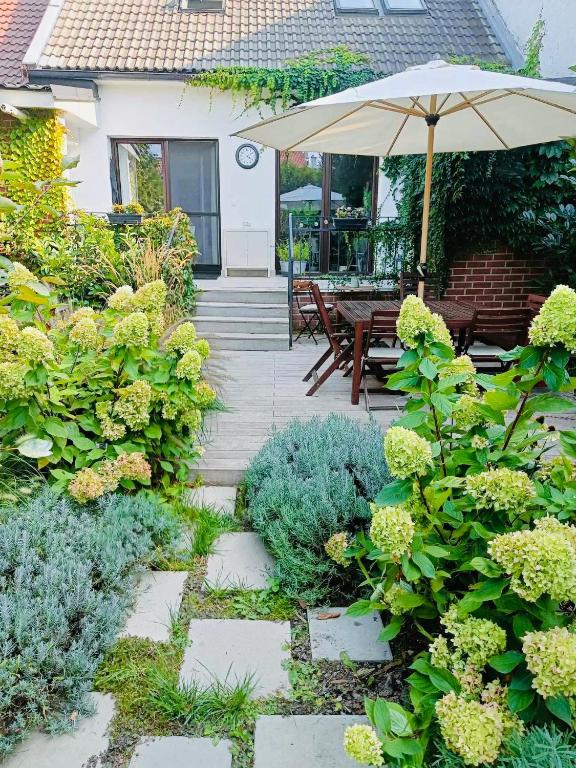 a garden with a patio with an umbrella at Apartmán v záhrade in Trnávka