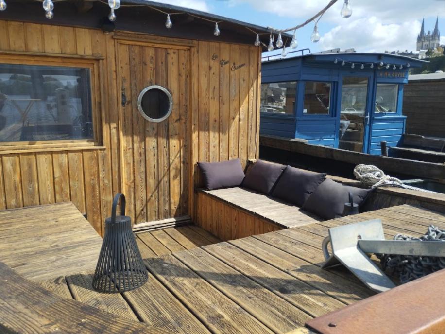 a wooden deck with a bench on a boat at La Toue Charme - Bateau traditionnel de la Loire in Angers