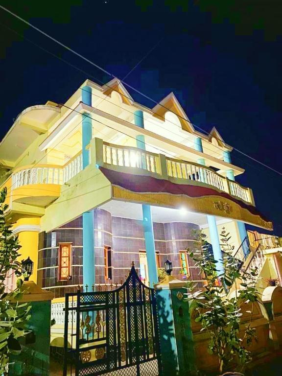 a building with a fence in front of it at Shri Laxmi Villa in Akalkot