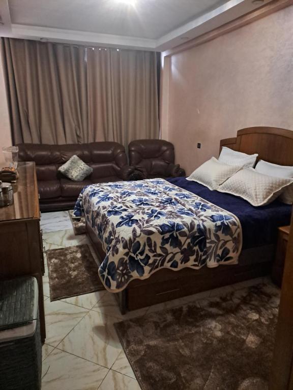 a bedroom with a bed and a couch at Haytam in Sale