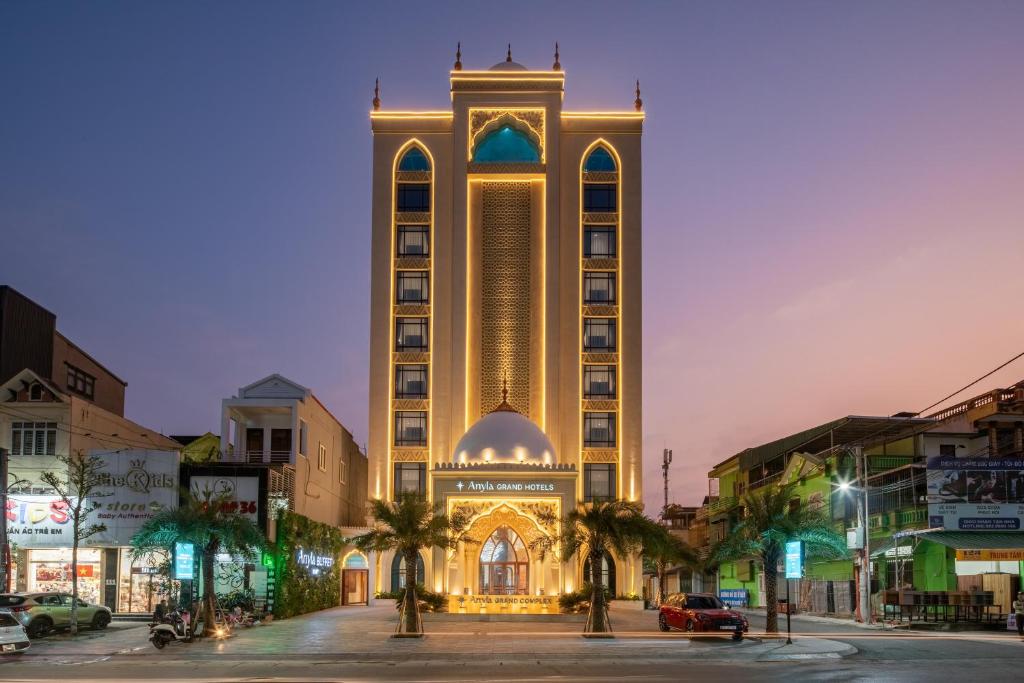 a large building with a clock tower in a city at Anyla Grand Hotels in Thanh Hóa