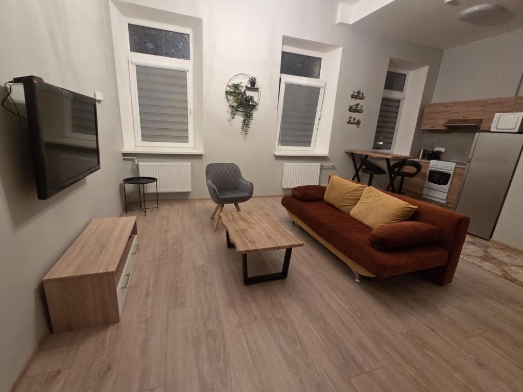 a living room with a couch and a table at Aurelija in Daugavpils