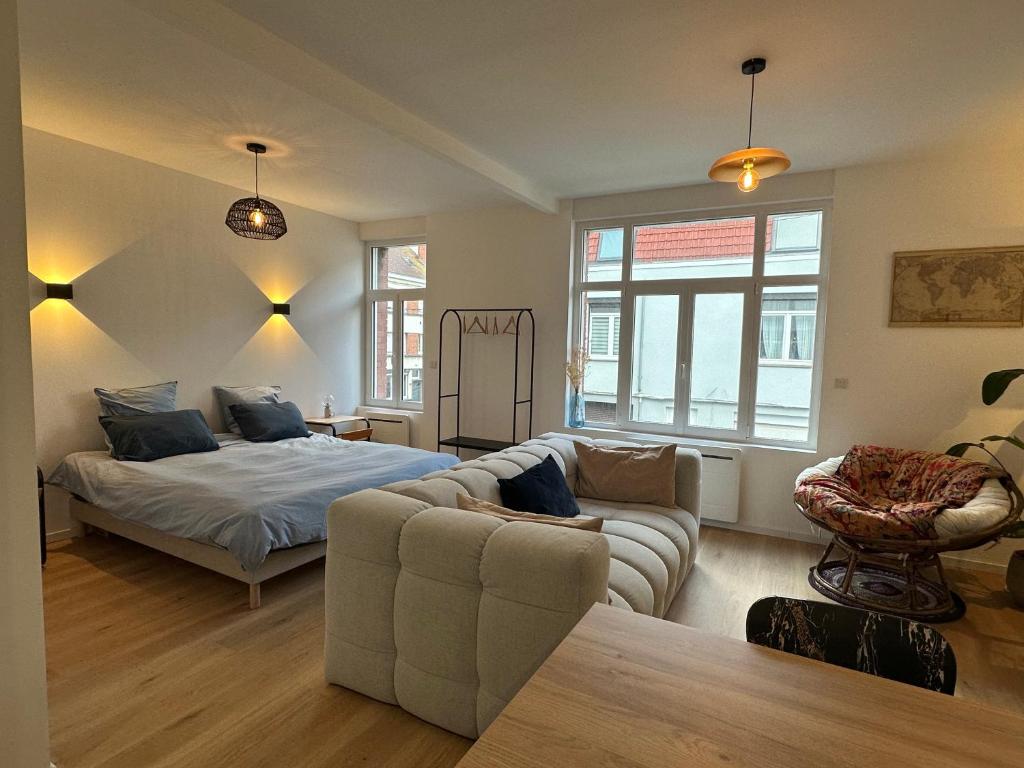 a living room with a bed and a couch at Appartement standing 500m de la plage ! in Dunkerque