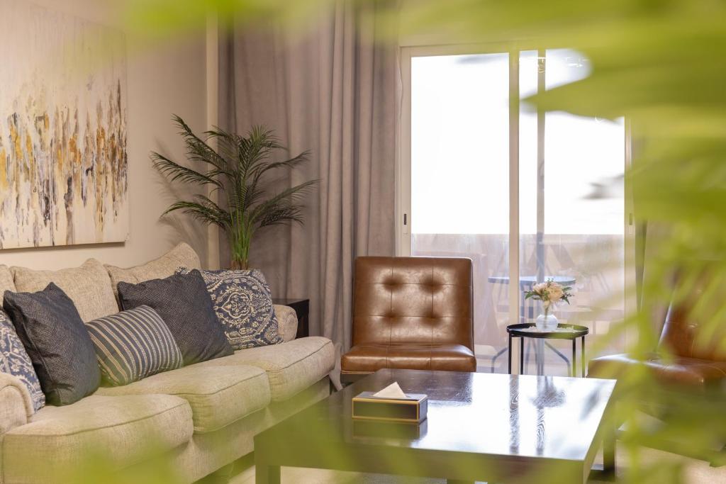 a living room with a couch and a chair at كنكون - Cancun in King Abdullah Economic City