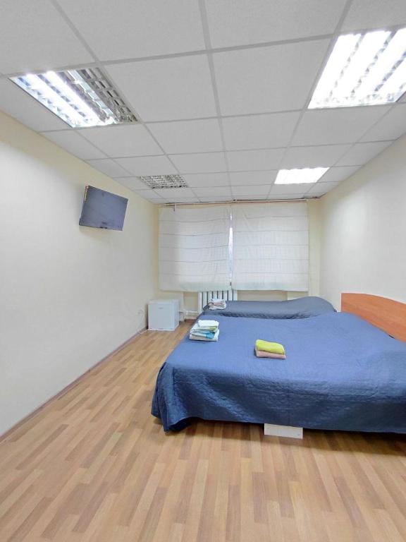 a bedroom with a bed with a blue comforter at Corona 11three-bedroom apartment in Cherkasy