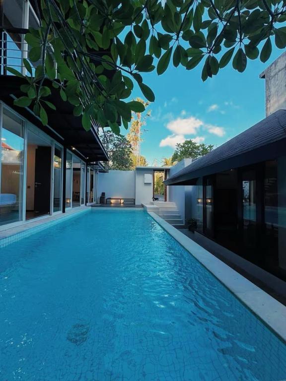 a swimming pool in the backyard of a house at 3BR Villa mit Pool, Villa Jovino, Jameja Kerobokan in Kerobokan