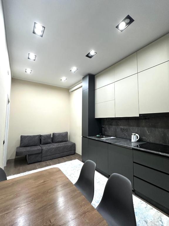 a living room with a table and a couch at Однушка в Асанбае in Bishkek