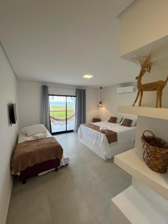 En eller flere senge i et værelse på Casa Mar dos Coqueirais