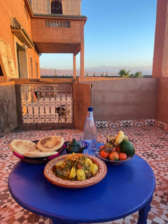 a blue table with plates of food on it at AISHAMA Healing House in Aït Ourir