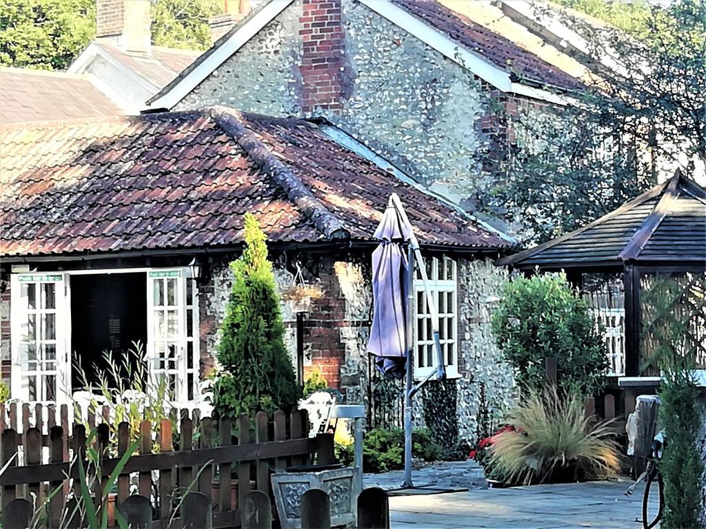 a house with an umbrella in front of it at Escape the Ordinary in Piddletrenthide