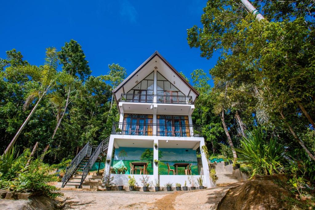 a house on the beach with trees at Sunny Hill Villa in Mirissa