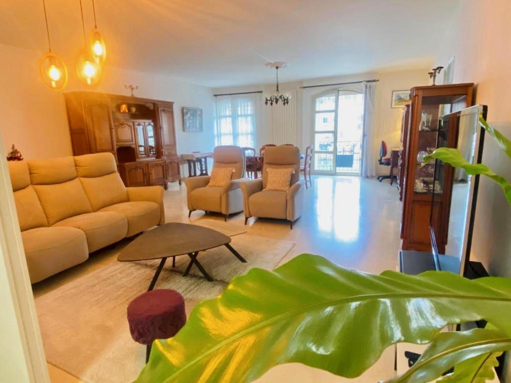 a living room with a couch and a table at ''Georgio'' Grand appartement traversant avec vue canal et parking in Sète