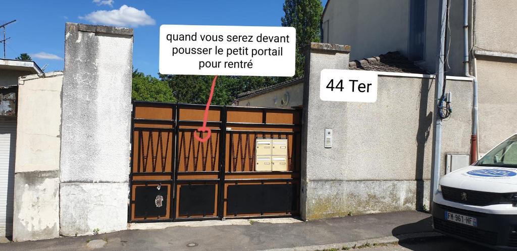 a garage door with a sign in front of it at Studio relaxe in Mitry-Mory