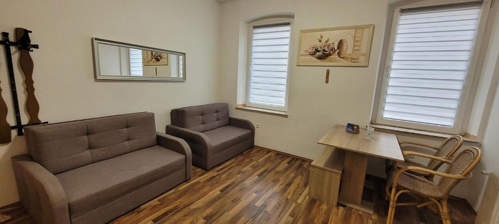 a living room with a couch and a chair at Privileg - NewTime in Viersen