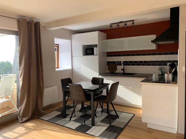 a kitchen with a table and chairs in a room at Studio "L'authentique" vue sur la Baie d'Authie in Berck-sur-Mer