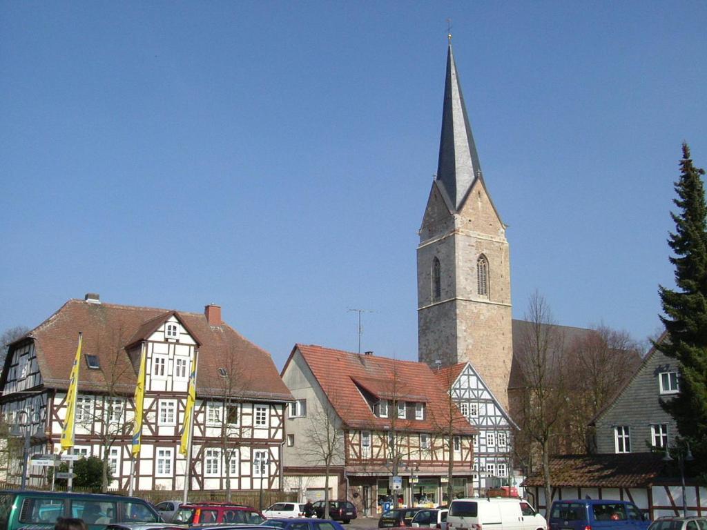 a church with a tall steeple in a town at Ferienwohnung Korbach in Korbach