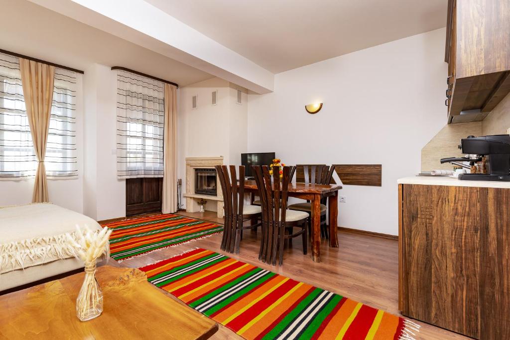 a living room with a table and a kitchen at Vacation Apartment in Starosel POOL & SPA in Starosel