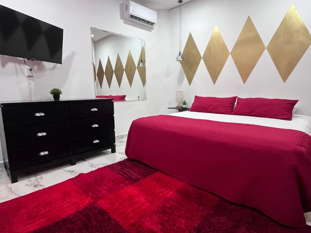 een slaapkamer met een groot bed met een rode deken bij La Puerta Blanca #5 in Puerto Vallarta