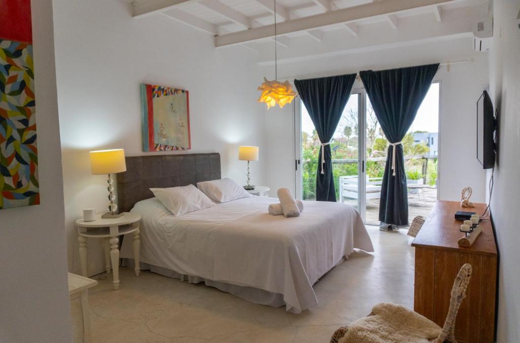 Ένα ή περισσότερα κρεβάτια σε δωμάτιο στο Casa Bikini