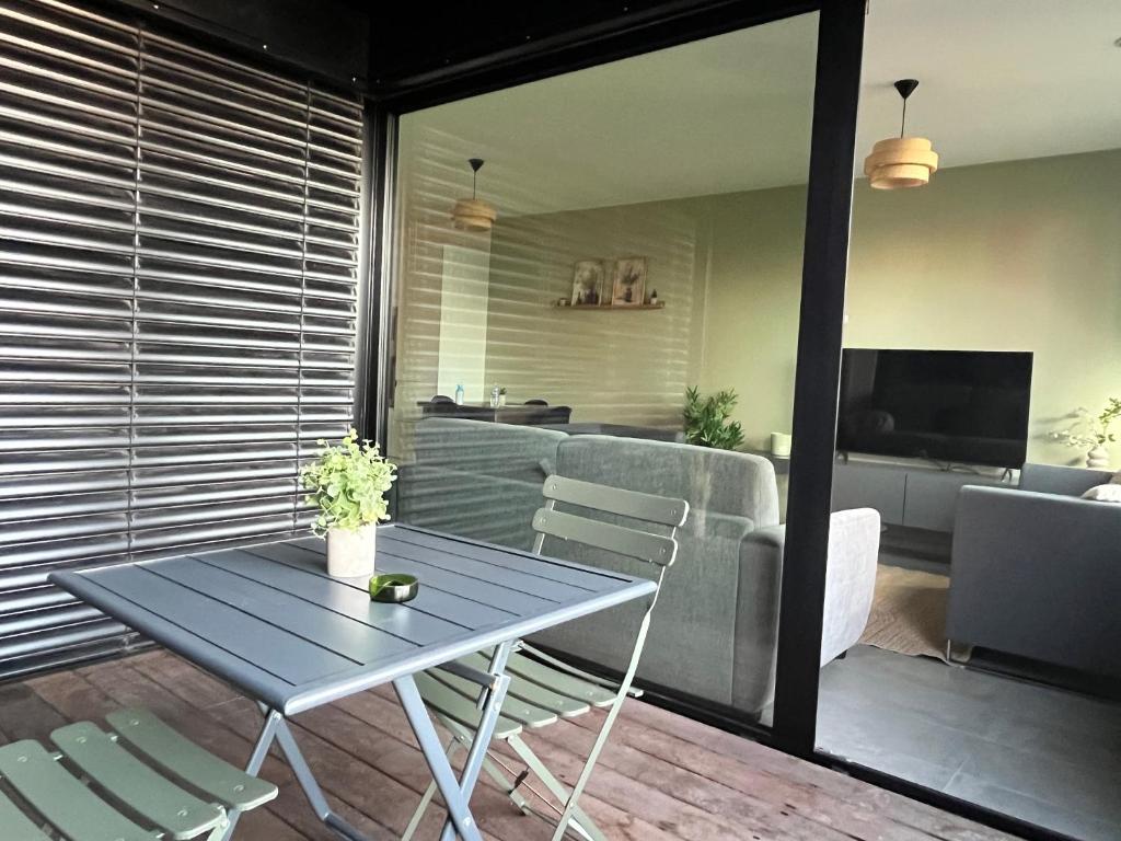 a room with a table and chairs and a living room at La Loggia - Appartement Terrasse Esch Belval in Esch-sur-Alzette