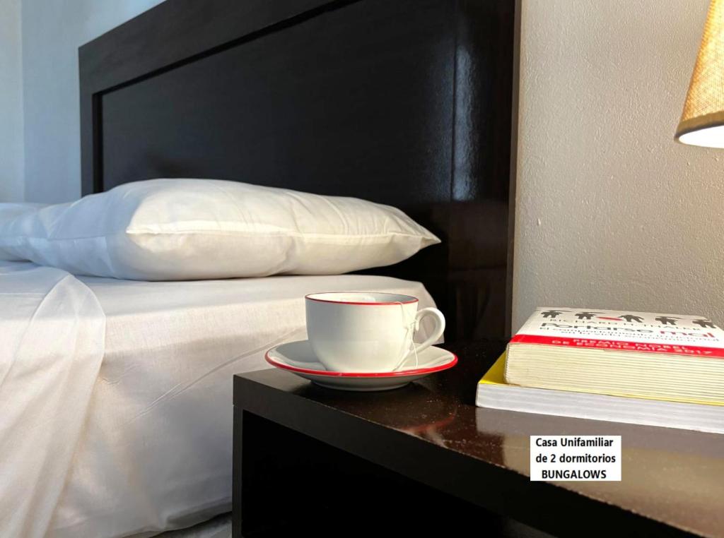 una tazza di caffè su un tavolo accanto al letto di Senda Marina Aparto Hotel a Punta del Este