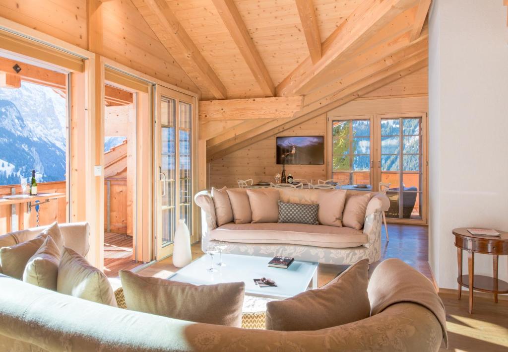 a living room with a couch and a table at Chalet Aberot in Wengen