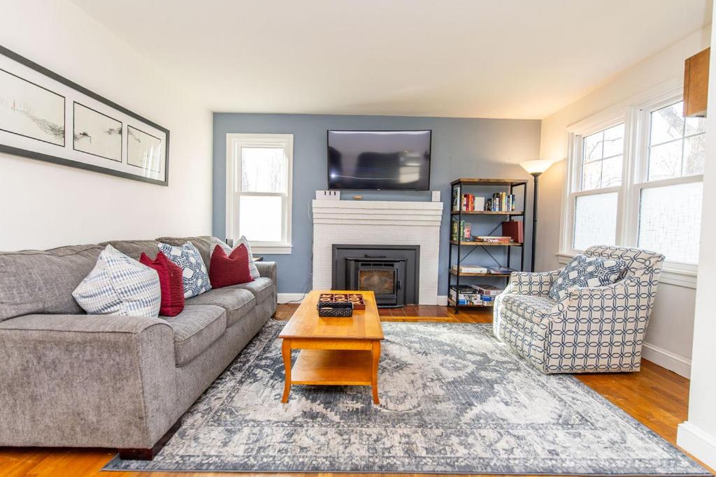 a living room with a couch and a fireplace at Pet Friendly Retreat Near Downtown Annapolis in Annapolis