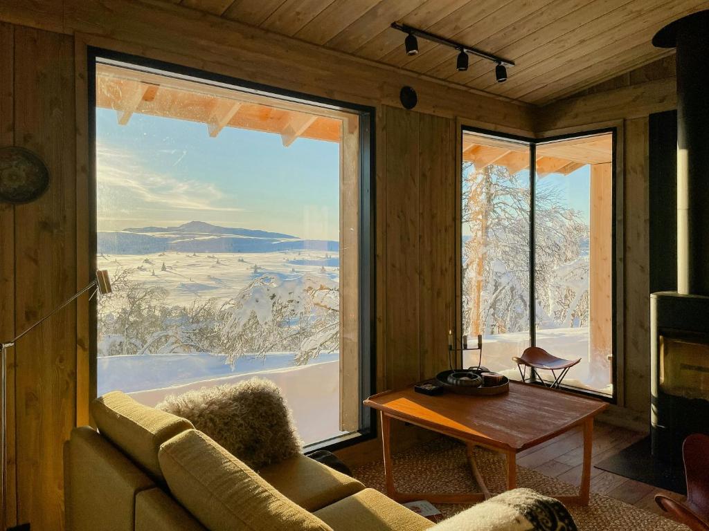 a living room with a large window with a view at Modern Cabin By The Ski Trails At Fagerhøy in Sør-Fron