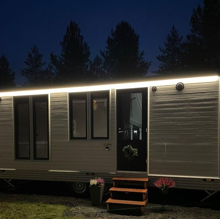 a silver trailer with a light on the side of it at Santa's little cottage in Rovaniemi