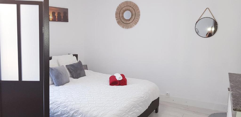 a bedroom with a bed with a red box on it at Cocon en vieille ville in Nancy