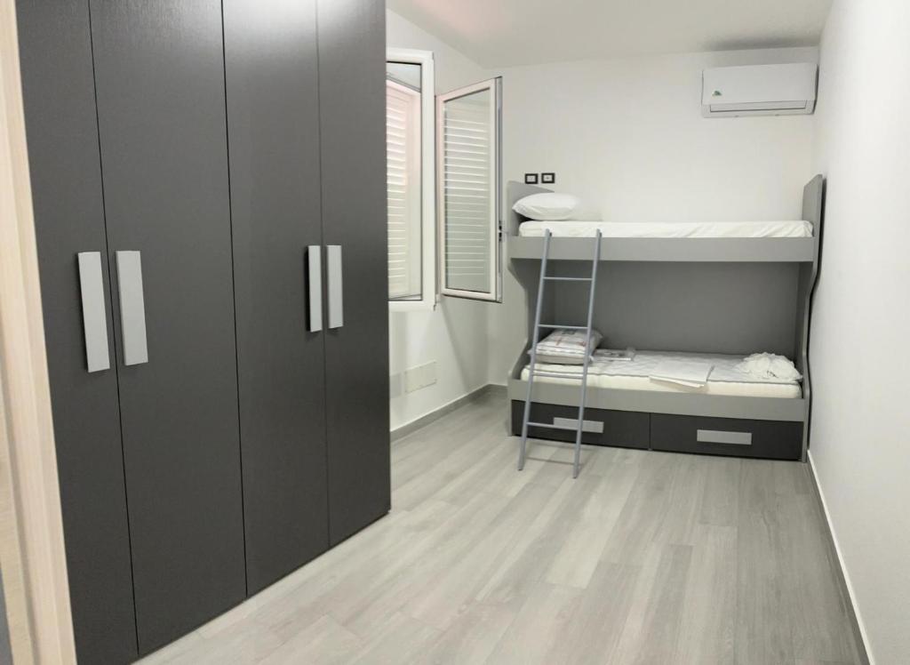 a small room with a bunk bed and a closet at BALISTRERI HOUSe in Trabia