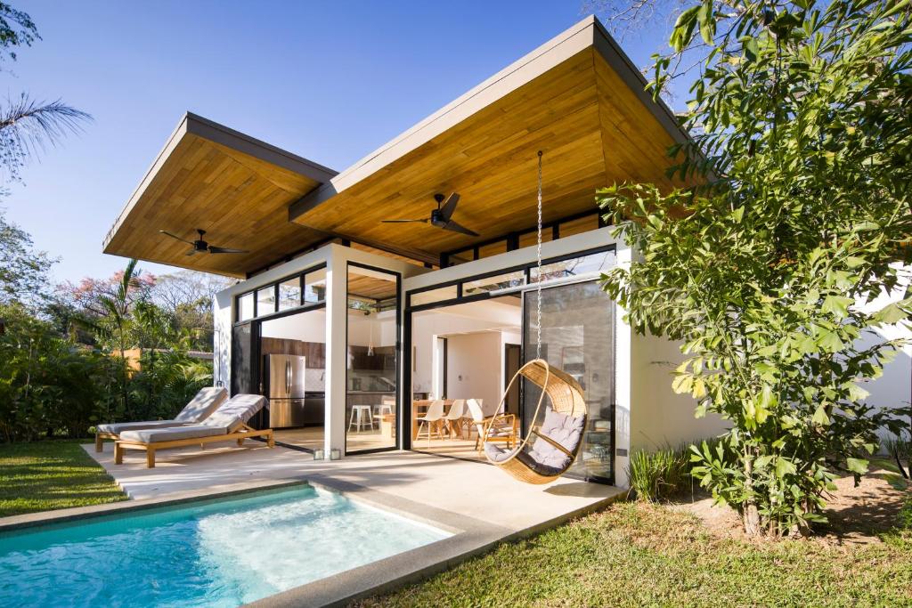 a house with a swimming pool in the backyard at Nalu Nosara Pool Villa Sol in Playa Guiones