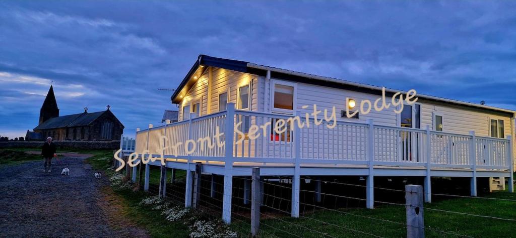 a house with lights on the side of it at Seafront Serenity Lodge in Newbiggin-by-the-Sea