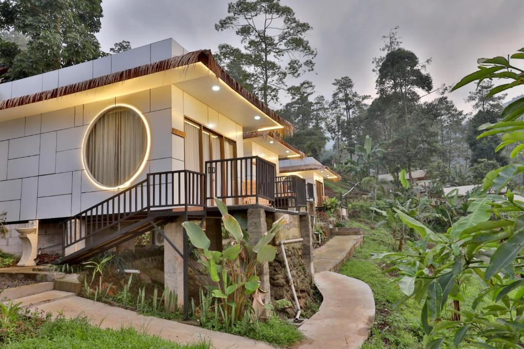 a house in the middle of a forest at The Full Hot Spring & Resort in Kemloko-gede