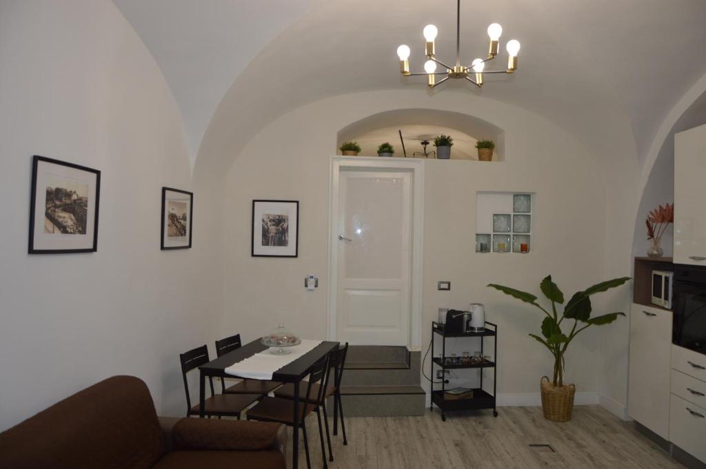 a living room with a couch and a table at MOUSUITE in Catania