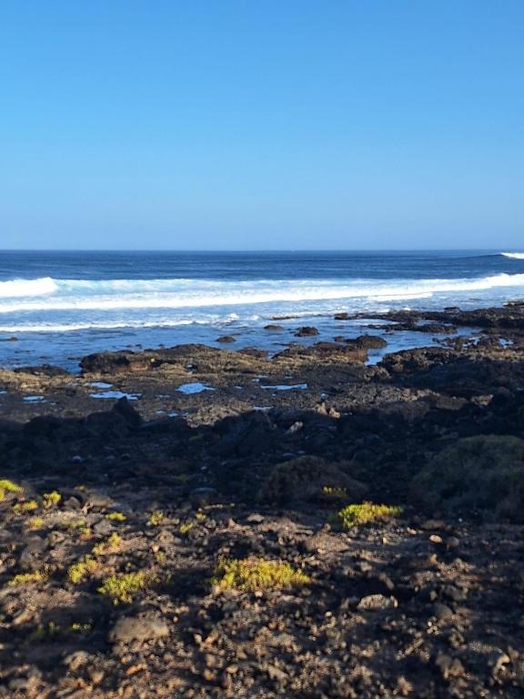 a view of the ocean from a rocky beach at La Caracola in La Santa
