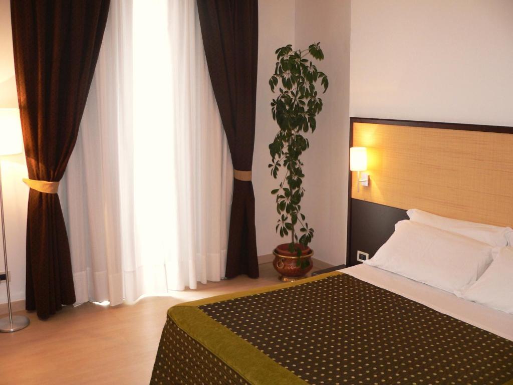 Postel nebo postele na pokoji v ubytování Il Grillo Hotel