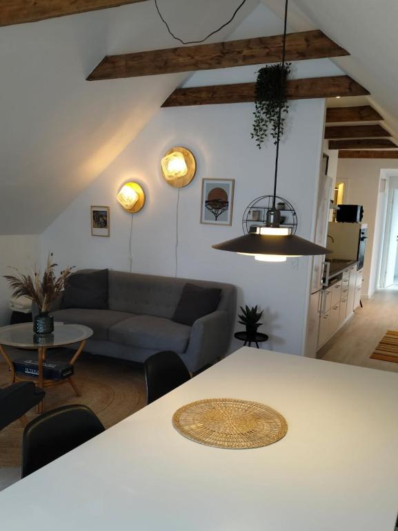 a living room with a table and a couch at BnB Hammerum in Herning