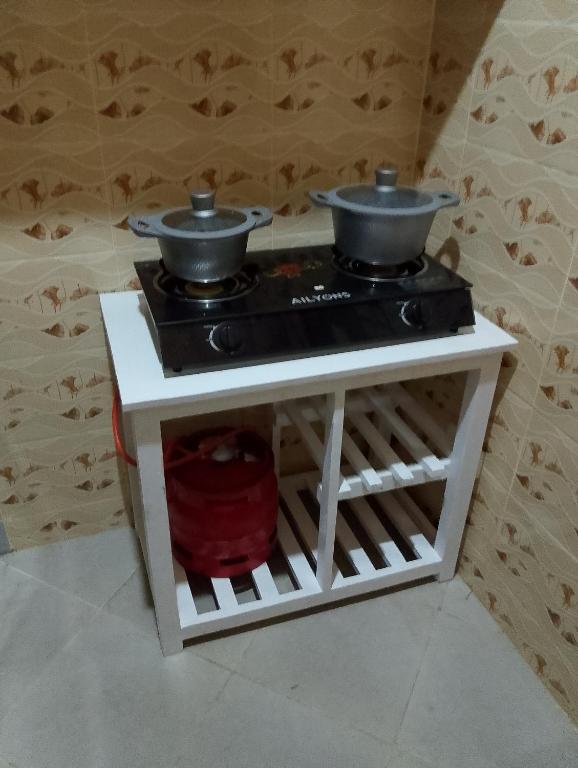 a stove with two pots on top of it at Lucy Chwada hostel in Watamu