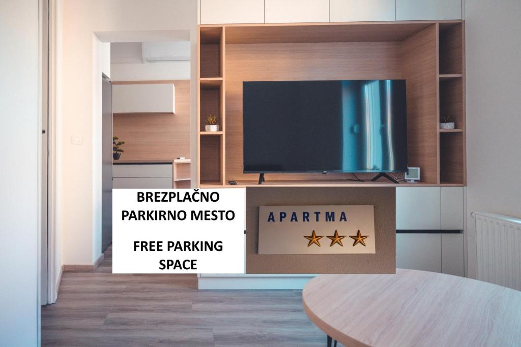 een woonkamer met een tv en een tafel bij Maribella Apartment in Maribor
