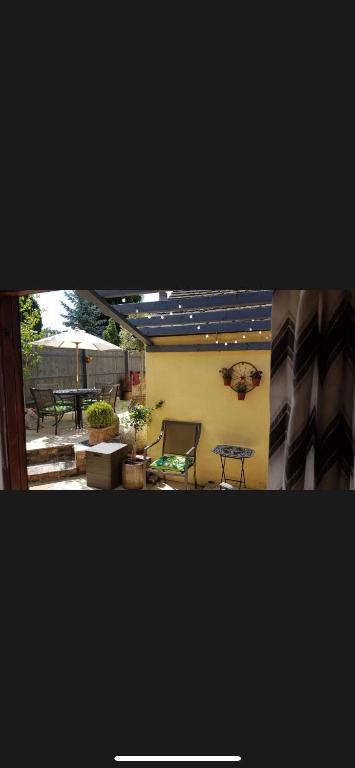 a view of a patio with a bench and a table at The Old Hanging Gate Inn in Madeley