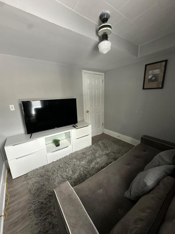 a living room with a flat screen tv and a couch at 2 Bedroom Cozy Accommodation in Windsor